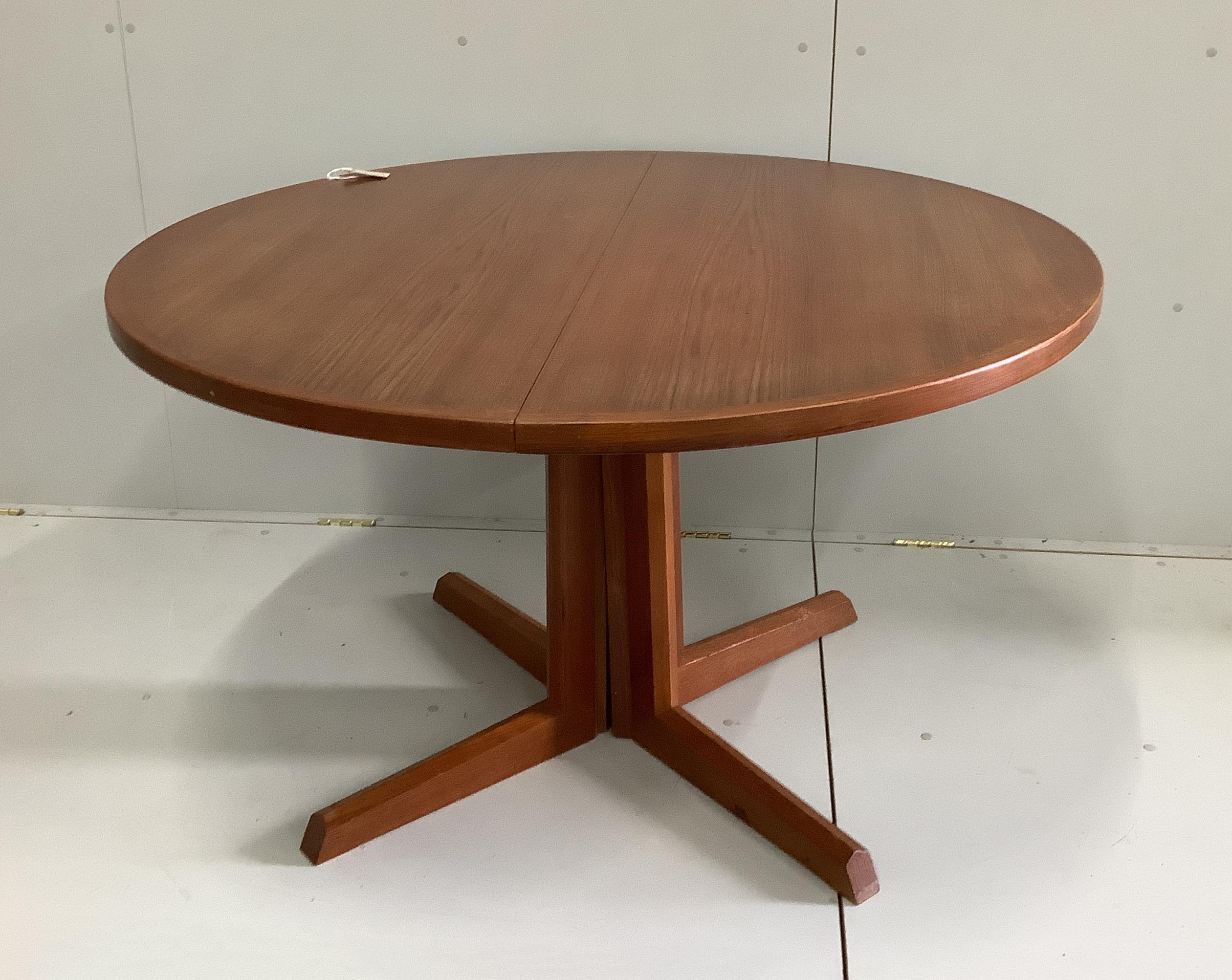 A Gudme Mobelfabrik mid century teak extending dining table, 220cm extended, two spare leaves, depth 122cm, height 73cm and four chairs